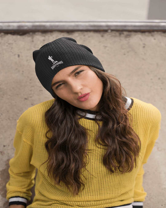 RUGBYNOMAD black organic combed cotton beanie on female model, adult size, rugbynomad original complete logo white