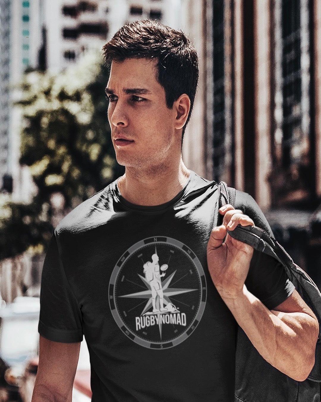 RUGBYNOMAD black organic cotton heavyweight unisex short sleeve streetwear t shirt original logo white , gray compass, male model , backpack, dark sunglasses, city bulidings